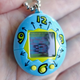 The Tamagotchi’s low-res screen is cute, but hindered by a reflective cover on the screen that reflects everything.